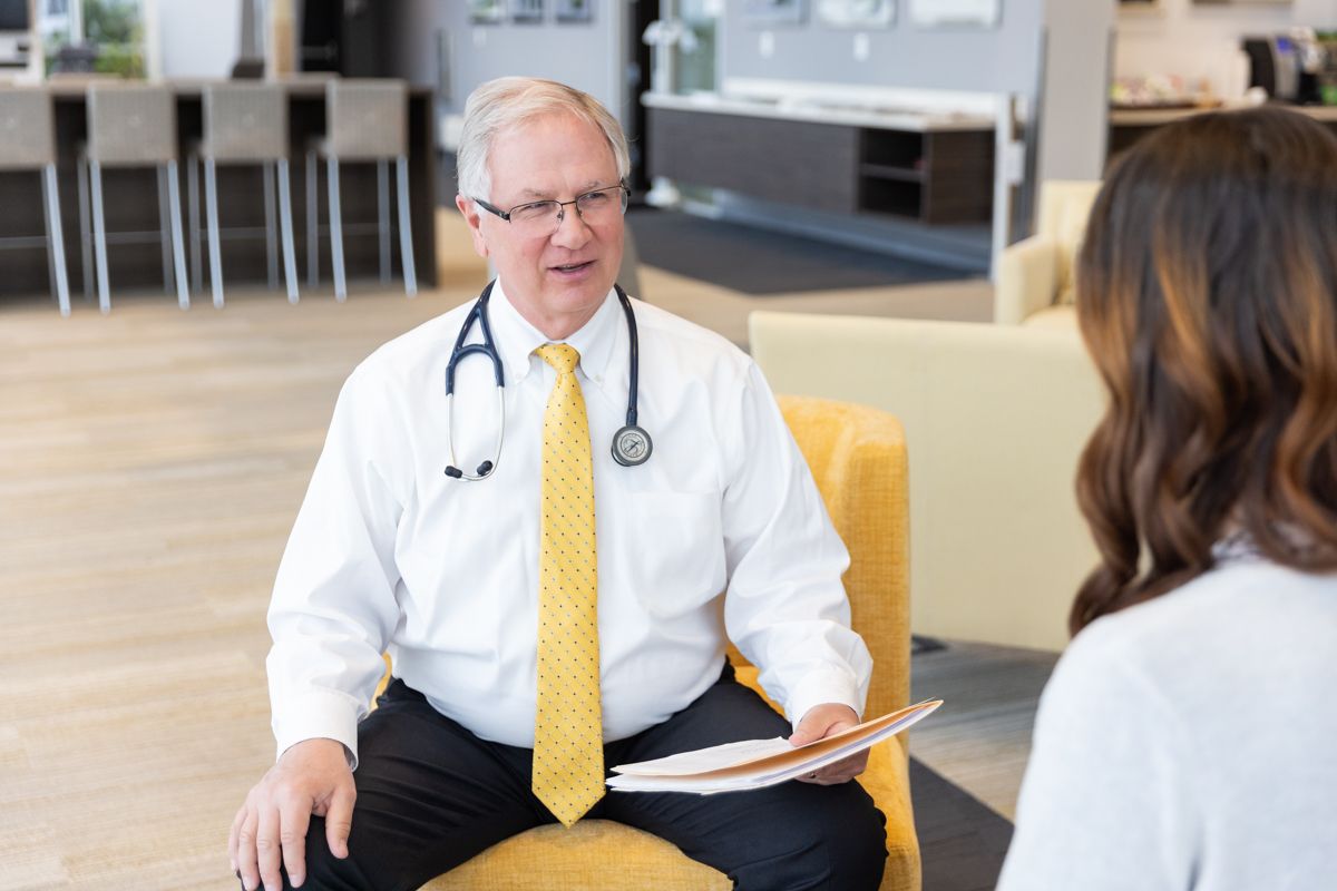 Dr. Edmondson handing a pilot their FAA medical certificate