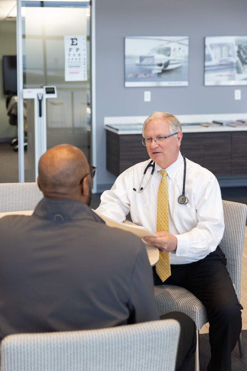 Dr. Edmondson explaining FAA medical requirements to a pilot at the Corporate Drive office