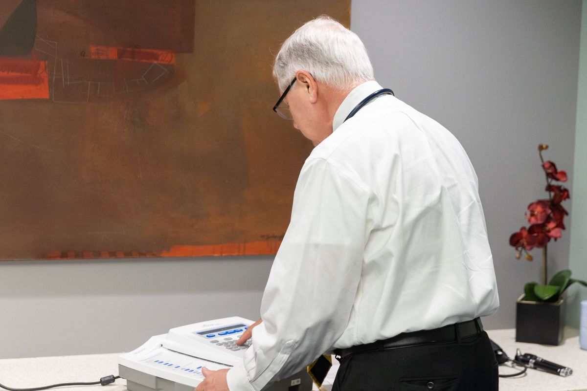 Dr. Edmondson reviewing an FAA-approved EKG tracing