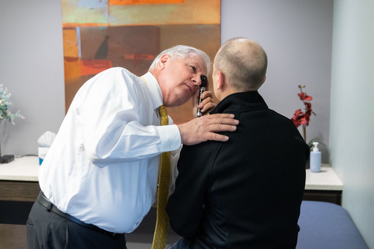 Dr. Edmondson performing an ear examination on a pilot