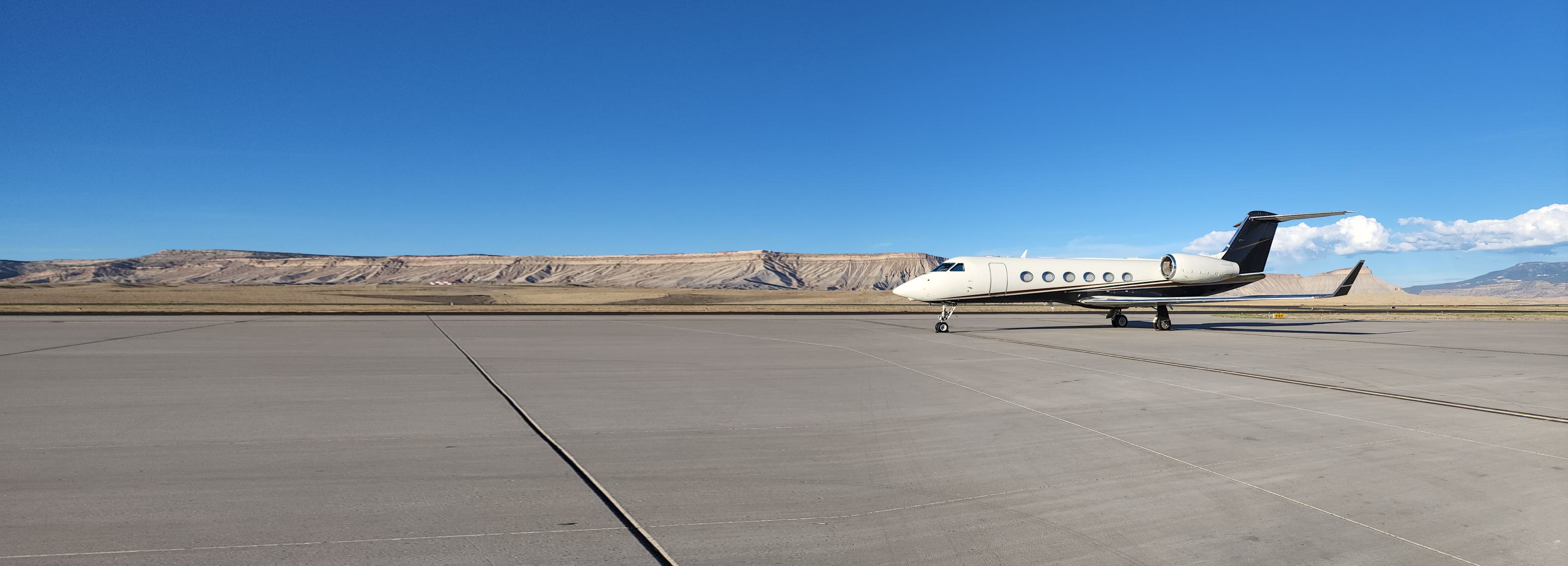 Business jet parked on a mountain-desert ramp