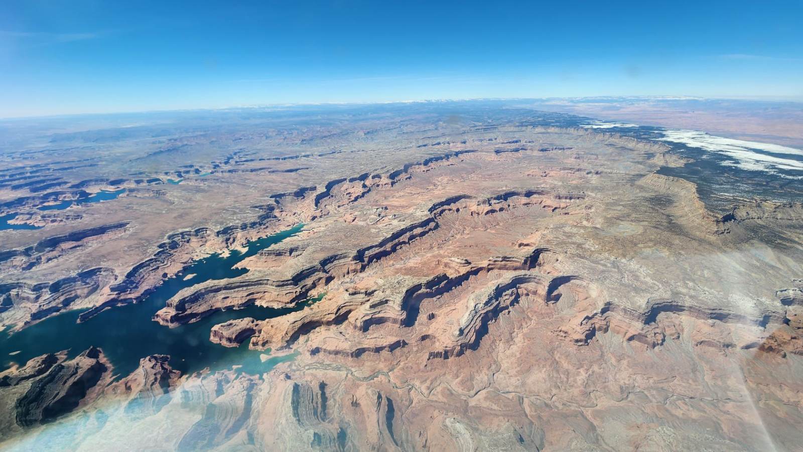 Lake Powell winding through the red rock canyons of Glen Canyon, seen from cruise altitude
